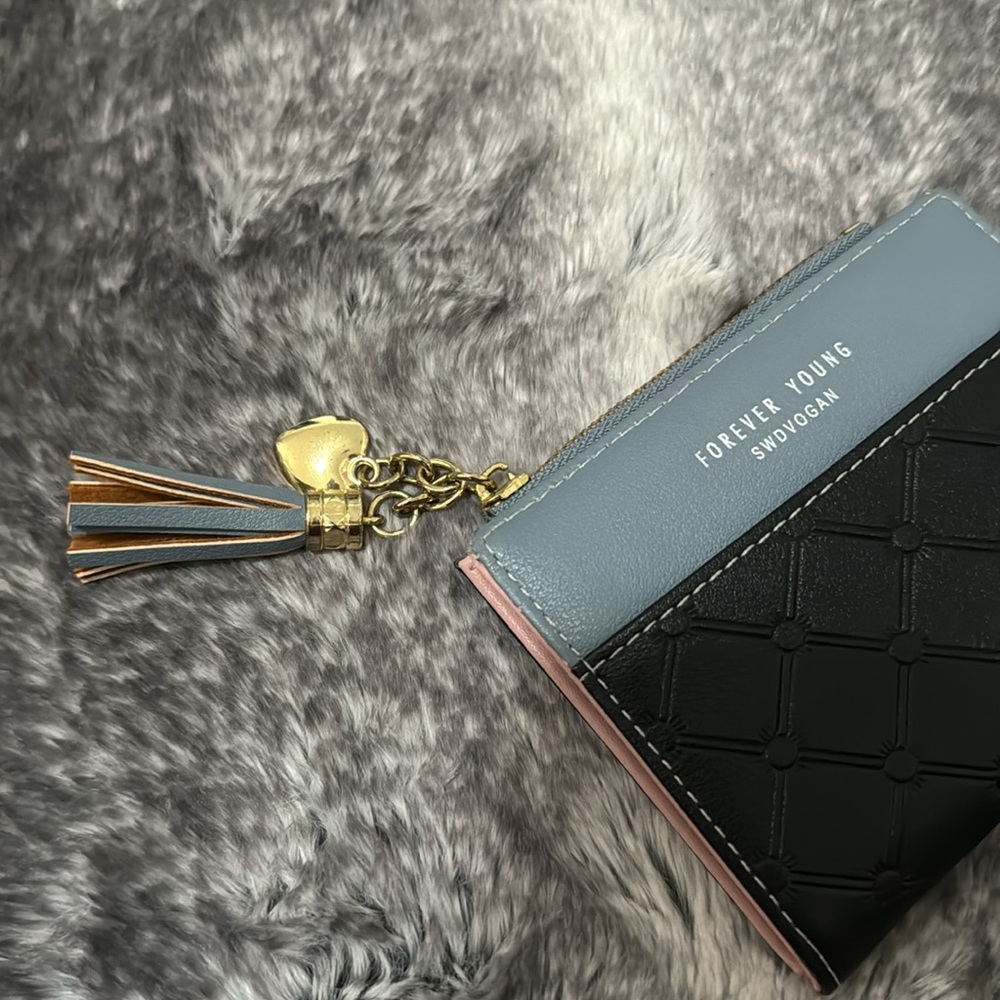 Forever young. Wallet. Never used. Holds cards, coins, and cash.